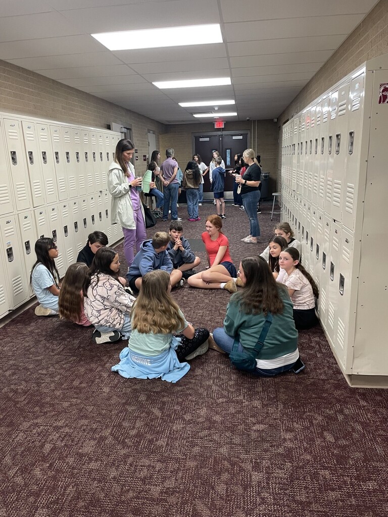 Marvelous moms guests sharing a story with students