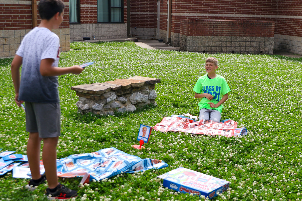 two students playing guess who