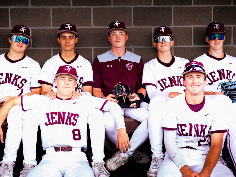 The 2026 seniors pose together in the dugout at their spring senior game with smiles on their faces