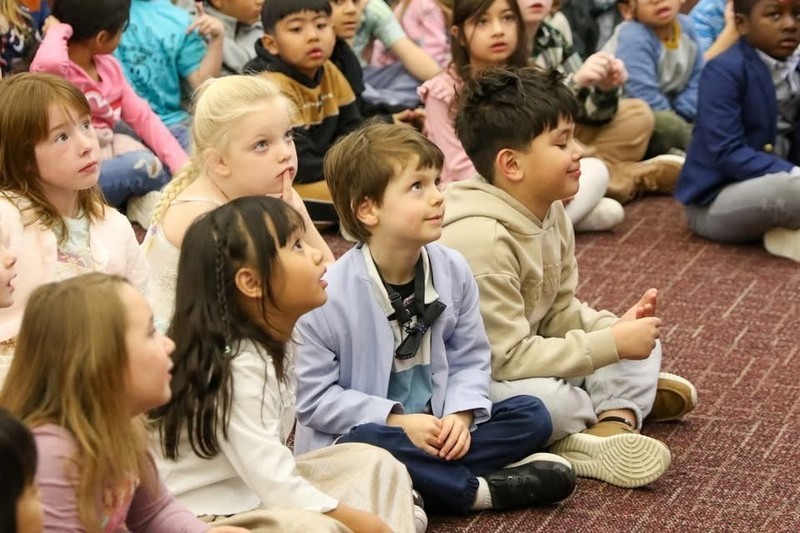 Students listening to Dr. Butterfield read Q and U