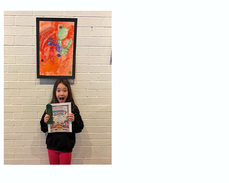 student standing next to artwork