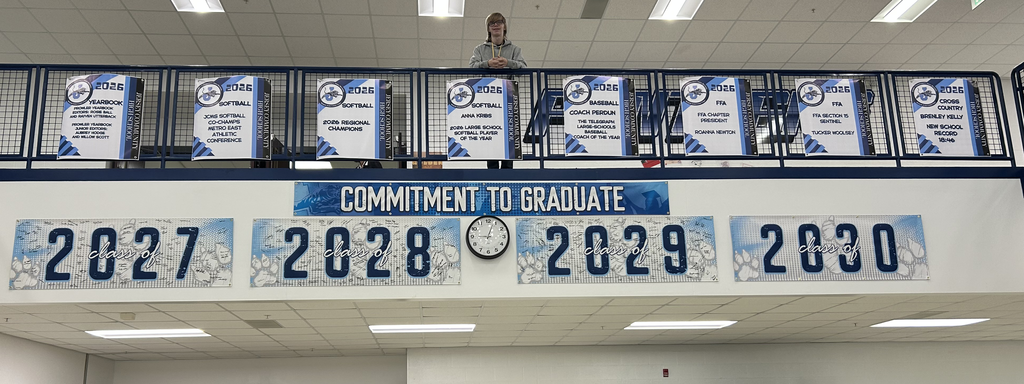 student with posters in front