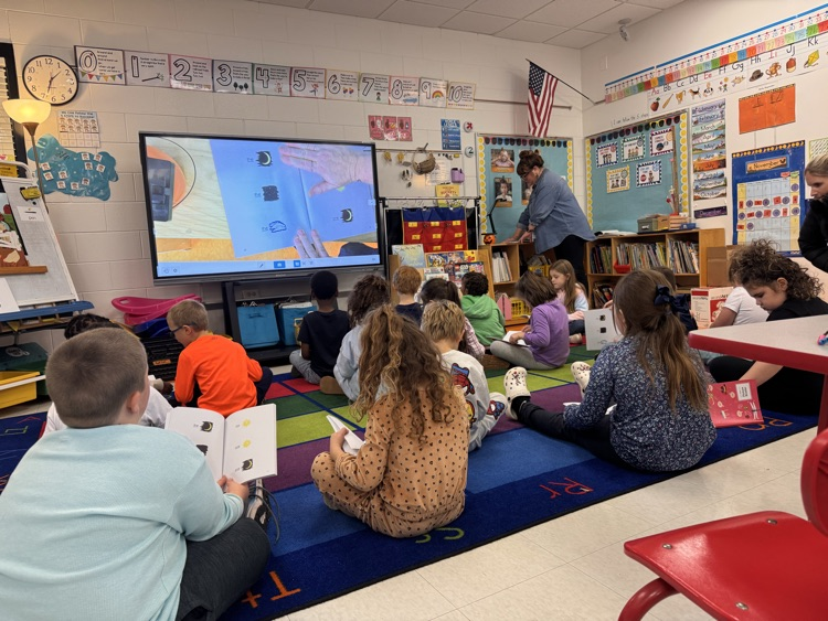 teacher and students reading together
