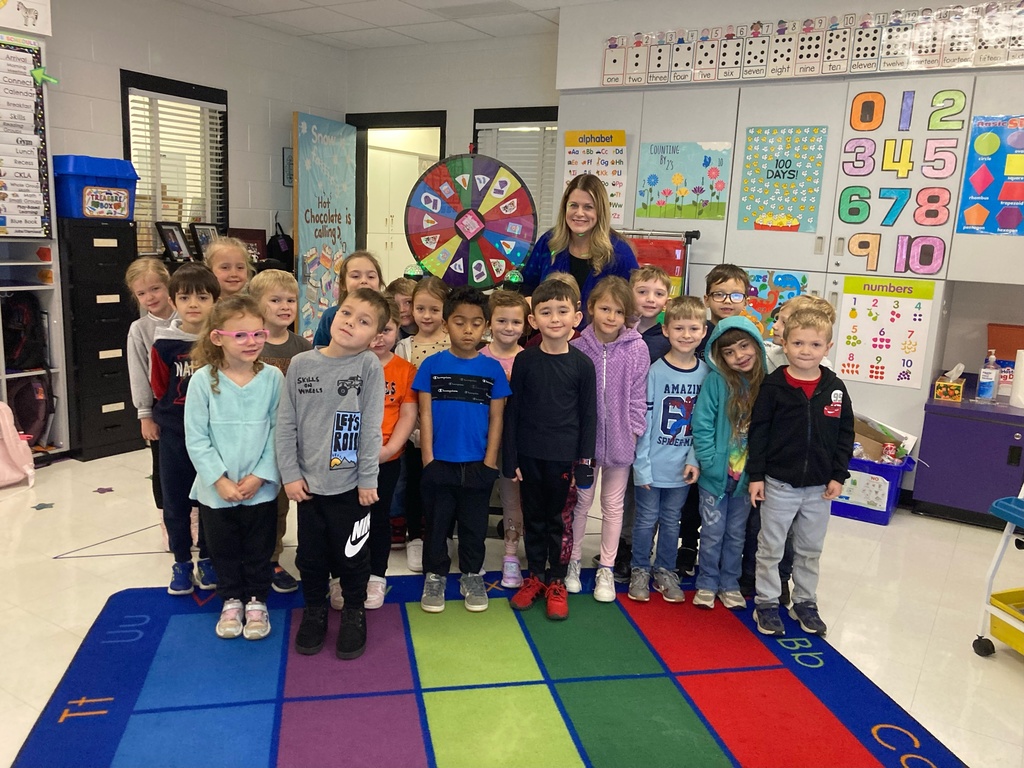 Students standing with prize wheel