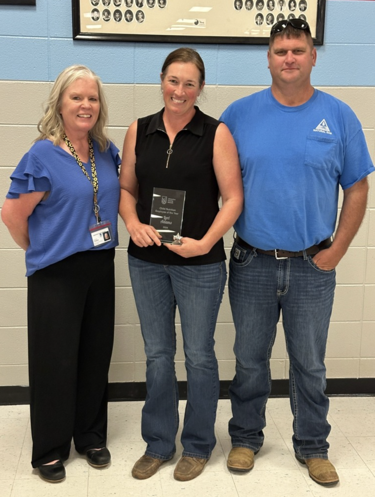 Lori with her husband and the Director of Child Nutrition