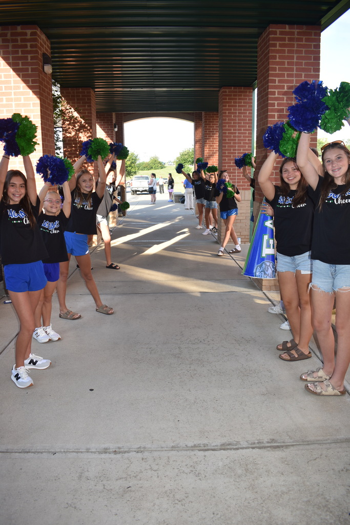 EJMS cheerleaders welcoming new 6th graders to the building.