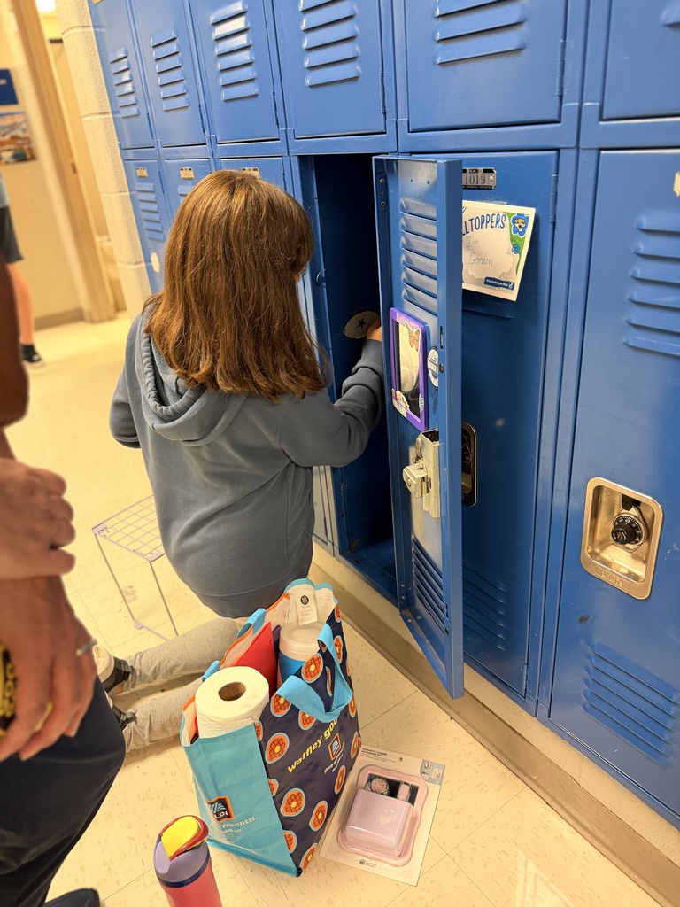 6th grade students and families setting up student lockers for the school year.