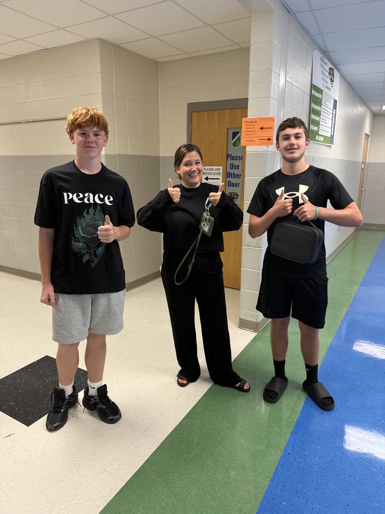 Mrs. Warren and her 8th grade students rocking black for 8th grade spirit day colors.