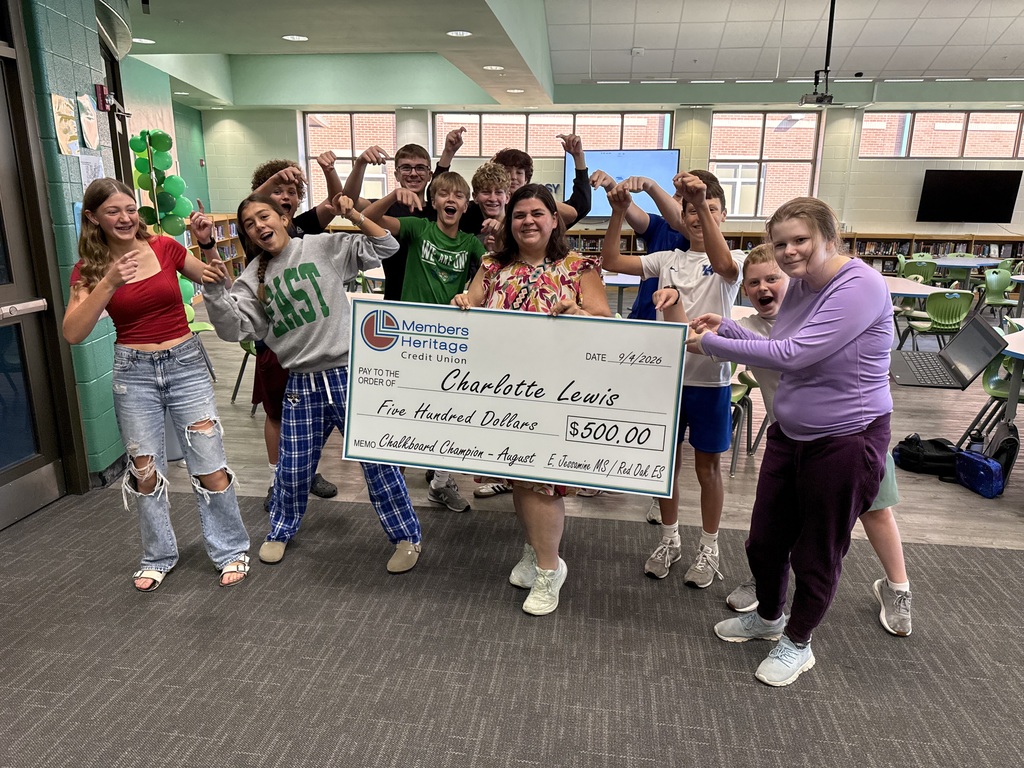 Ms. Lewis holding her $500 check for being selected as the WKYT Chalkboard Champion.
