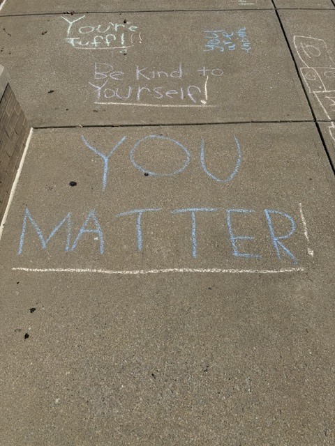 Messages of positive affirmation decorating the walkways of EJMS for 988 day.