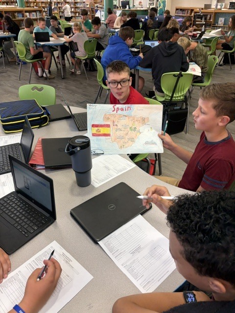 EJMS students collaborating to make posters celebrating Hispanic Heritage Month.