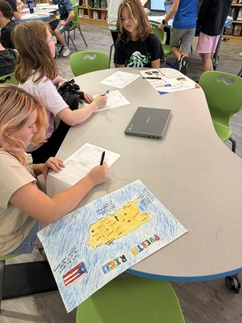 EJMS students collaborating to make posters celebrating Hispanic Heritage Month.