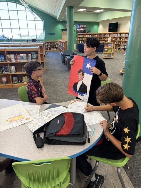 EJMS students collaborating to make posters celebrating Hispanic Heritage Month.