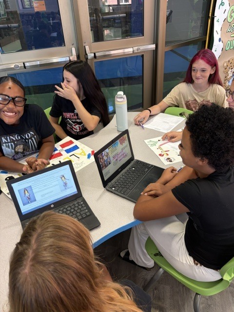 EJMS students collaborating to make posters celebrating Hispanic Heritage Month.