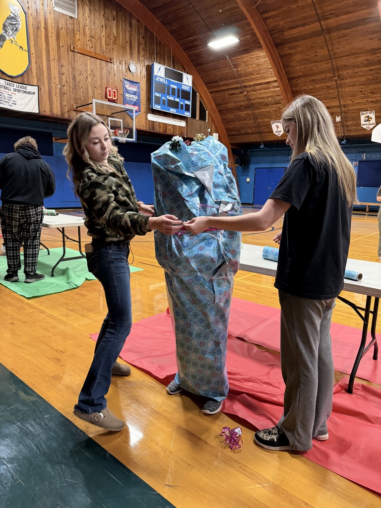 Teacher wrapped in blue snowflake wrapping paper