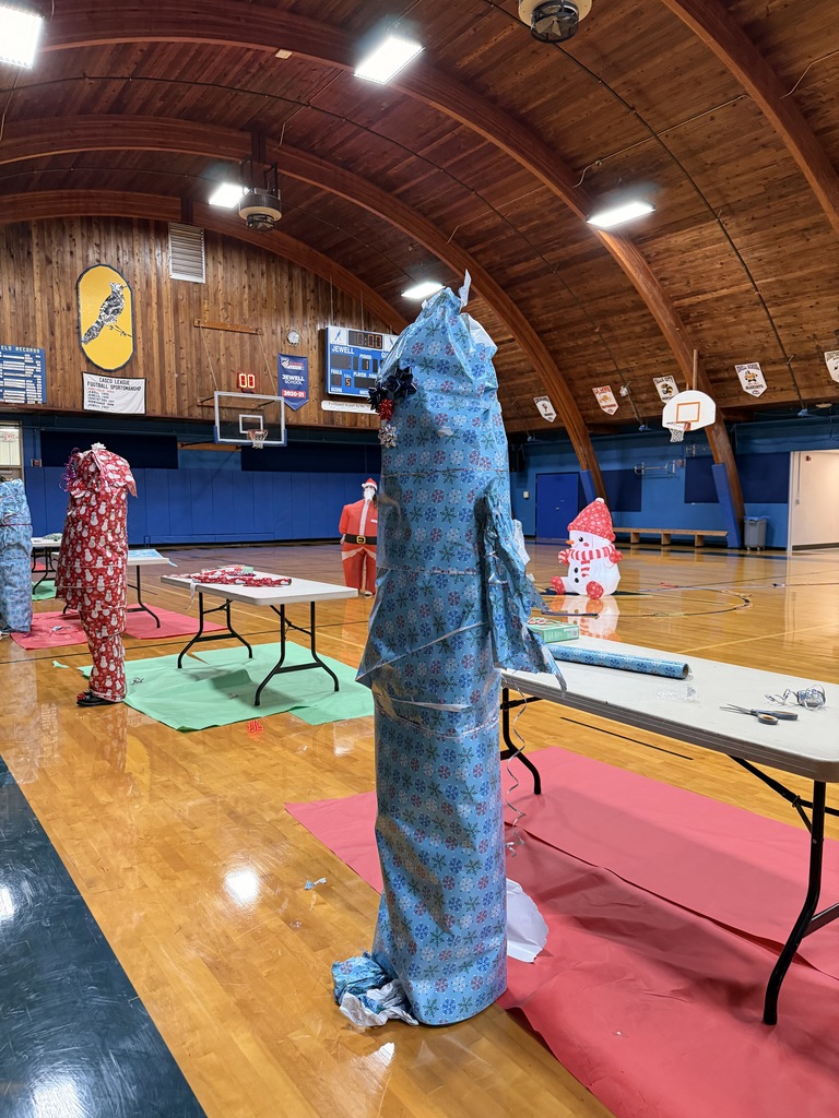Teacher wrapped in blue snowflake wrapping paper