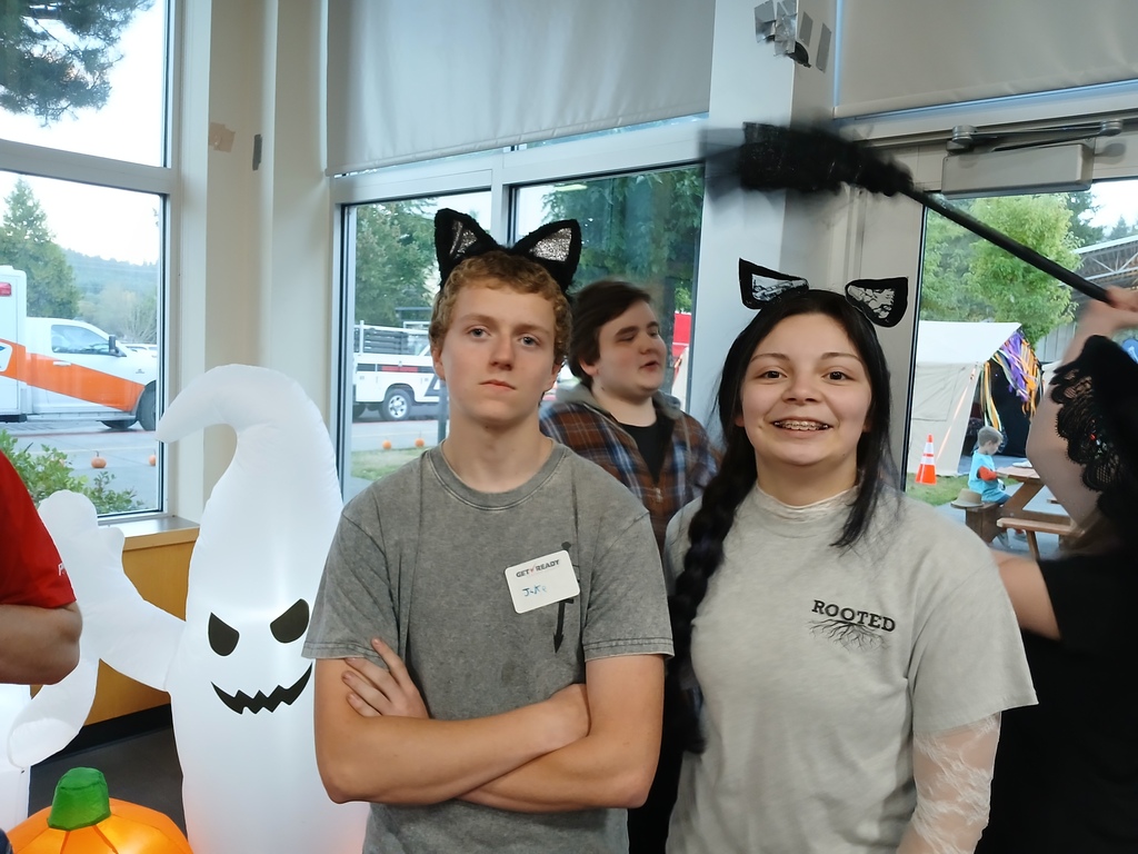 Two FFA students posing for a photo with a white blowup ghost.