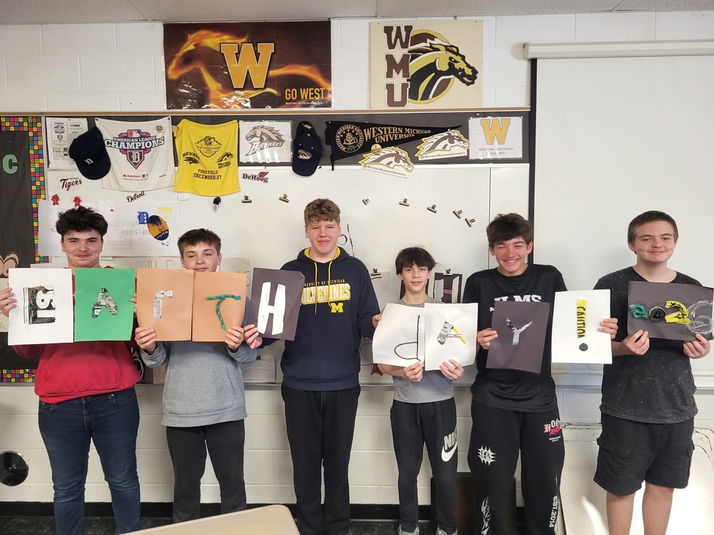 Middle School students celebrating picking up trash and creating posters. They also used the trash to create art! 