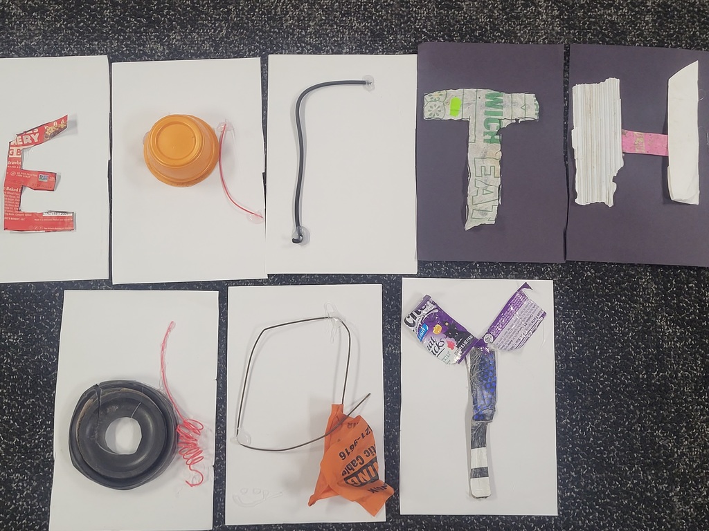 Middle School students celebrating picking up trash and creating posters. They also used the trash to create art! 