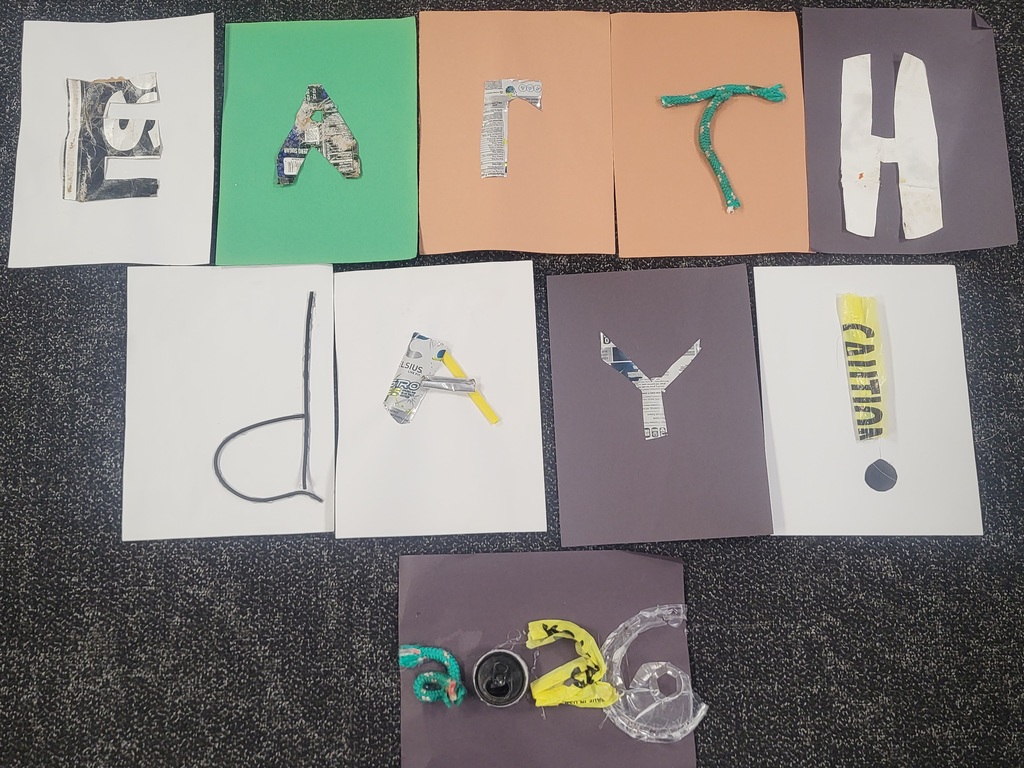 Middle School students celebrating picking up trash and creating posters. They also used the trash to create art! 