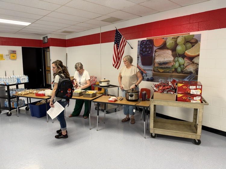 Mrs. Idalski and Mrs. Springer in the cafeteria ready to hand out walking tacos!