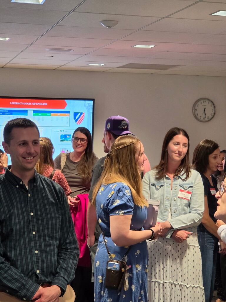 Candid photo of people talking to eachother at JAA meet and greet.