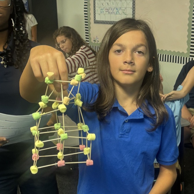 Student showing completed models