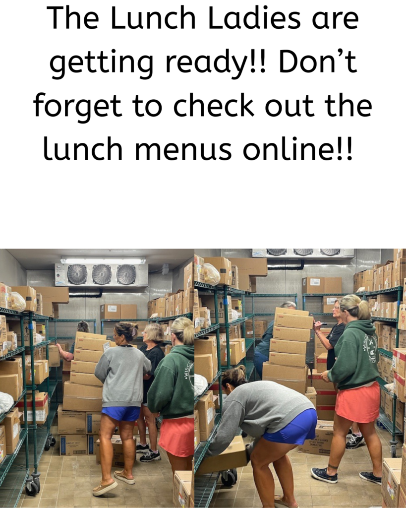 lunch ladies putting boxes of food in freezer