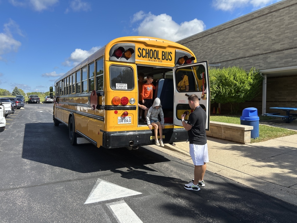 Students exiting school bus from emergency exit