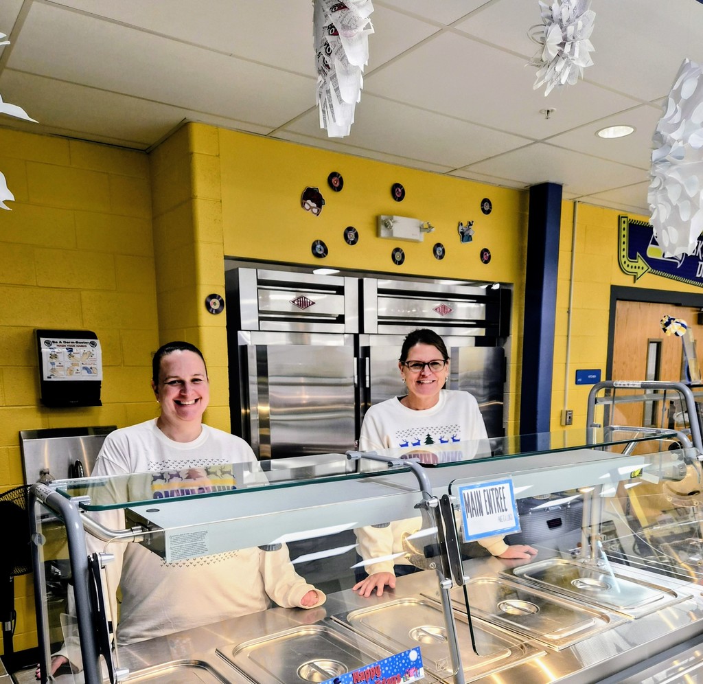 JHS lunch ladies posing behind serving line