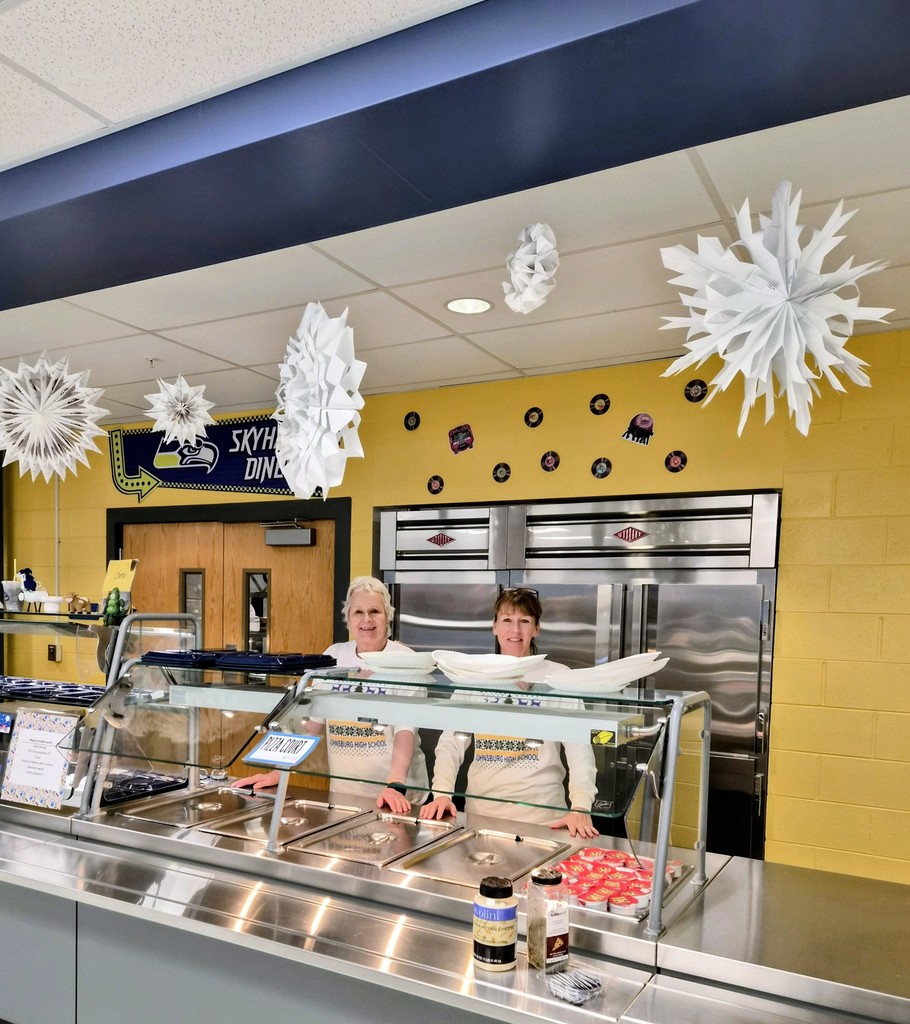 JHS lunch ladies posing with huge snowflakes