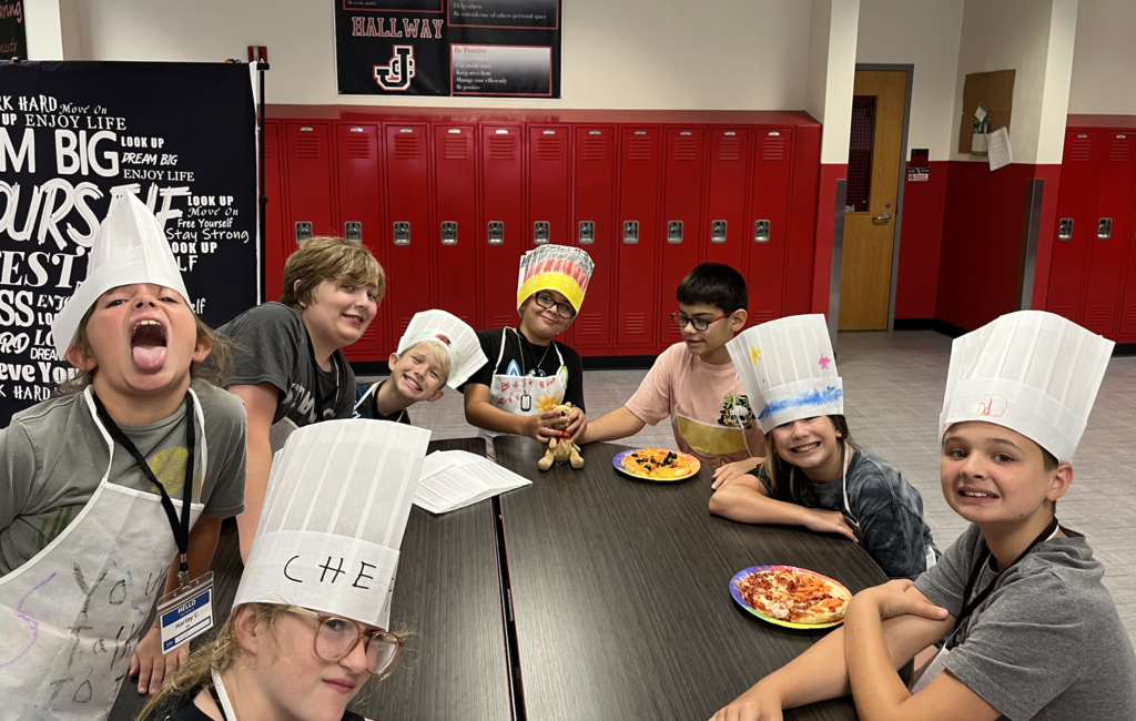 Summer camp participants with pizza 