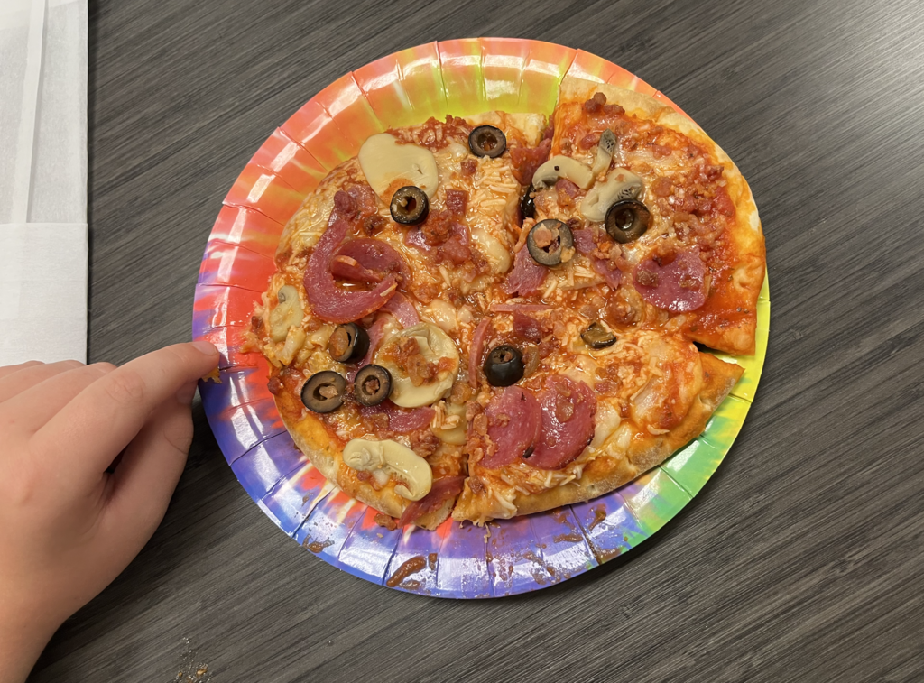 Summer camp participants with pizza 