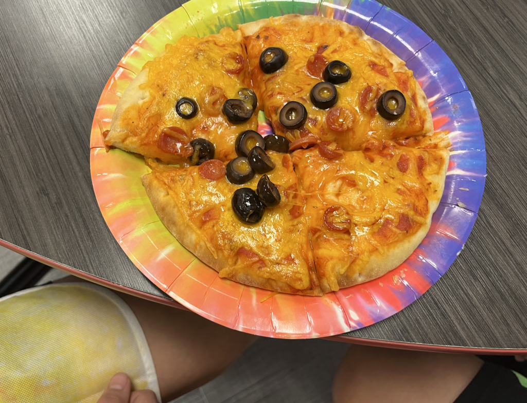 Summer camp participants with pizza 