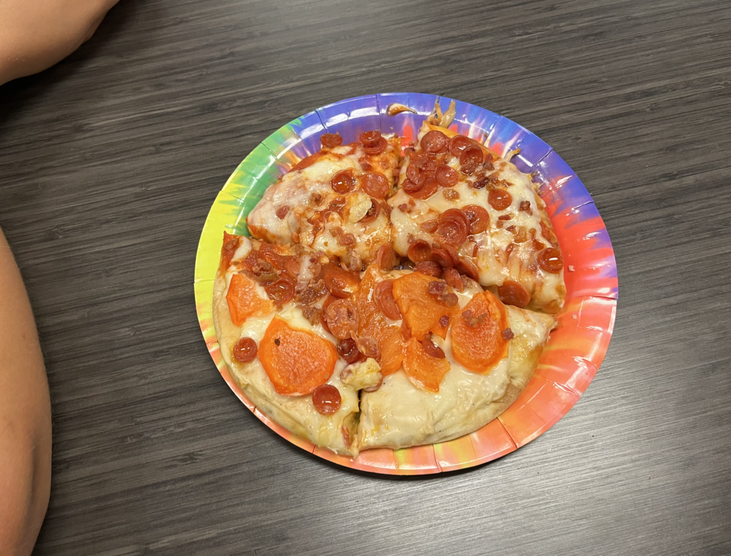 Summer camp participants with pizza