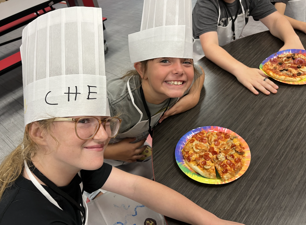 Summer camp participants with pizza