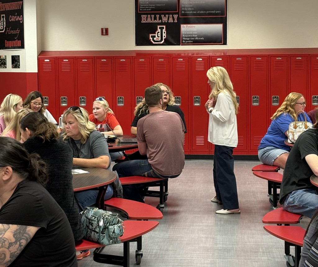Parents and students sit in cafeteria listening to presentation for JCHS FAFSA Completion Night. 
