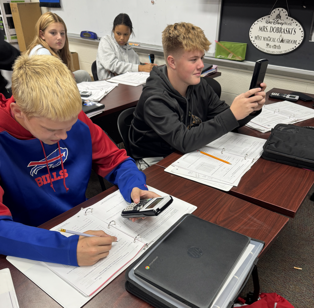 Middle school advanced math students use graphic calculators 