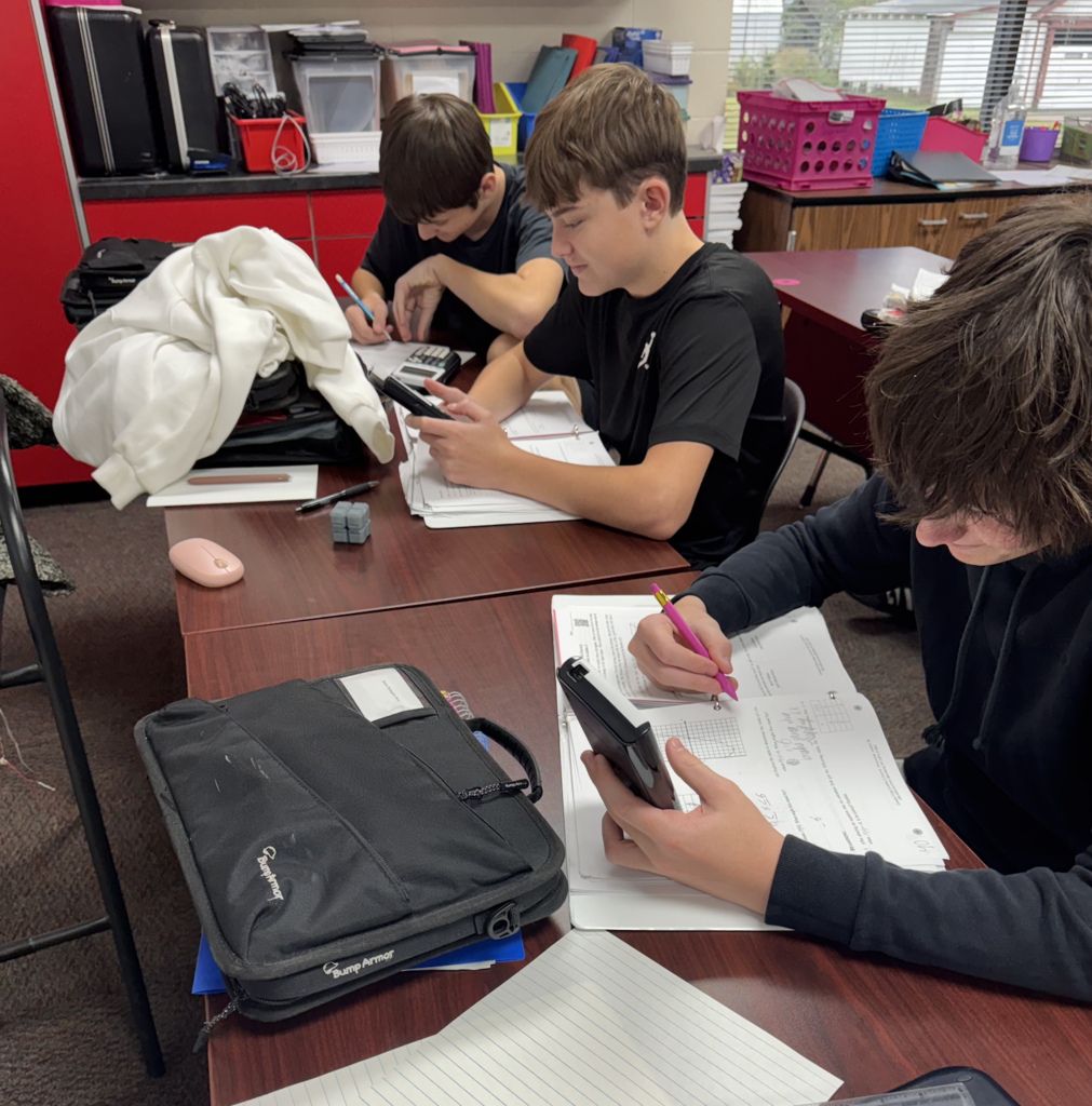 Middle school advanced math students use graphic calculators 