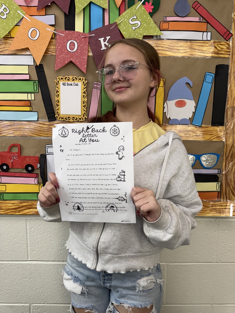 Seventh Grade students show off their pen pal letters