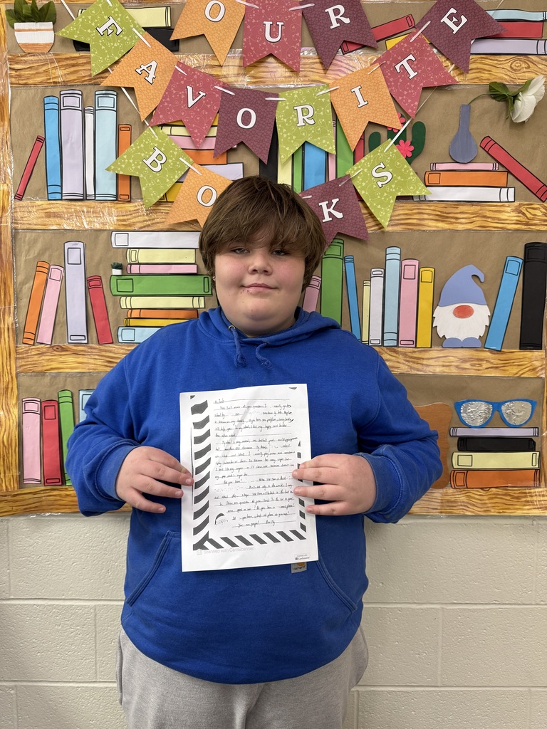 Seventh Grade students show off their pen pal letters