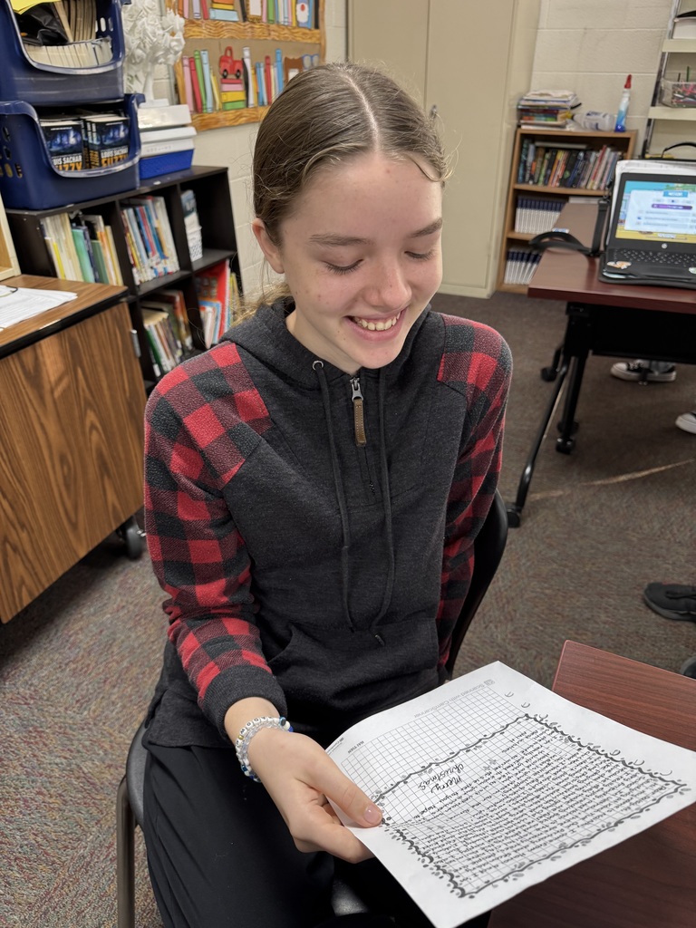 Seventh Grade students show off their pen pal letters