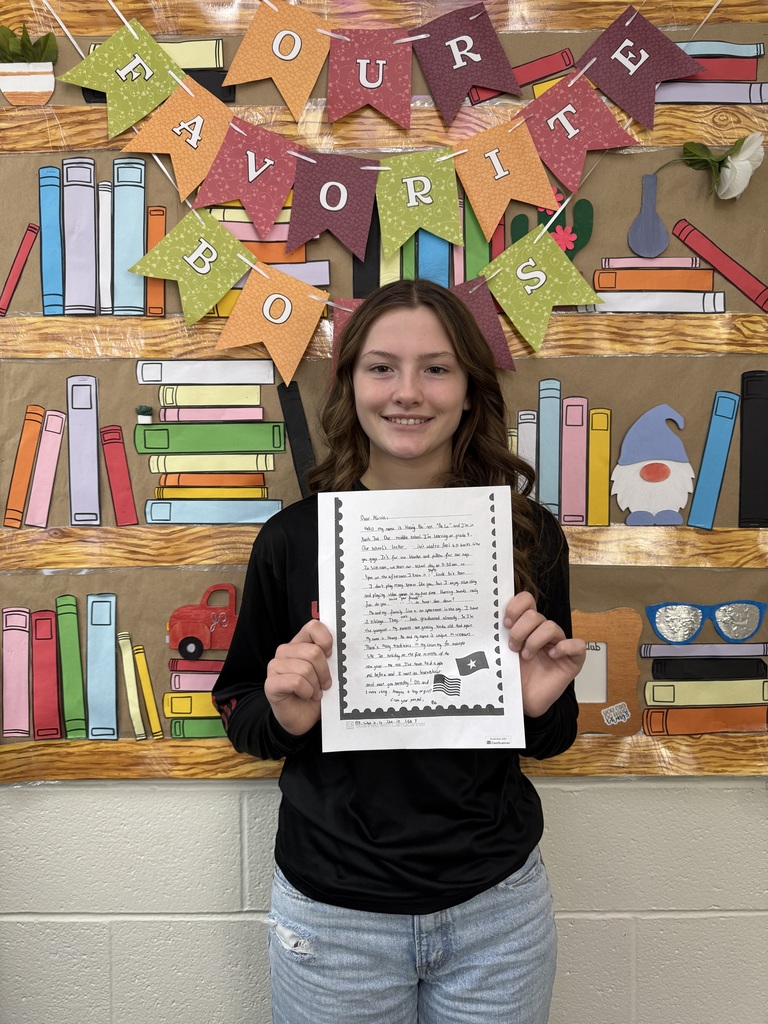Seventh Grade students show off their pen pal letters