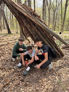students demonstrate the sturdiness of their shelter