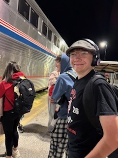 student council members await the train