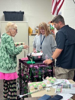 Ms Beth takes around pink and green goodies to the teachers