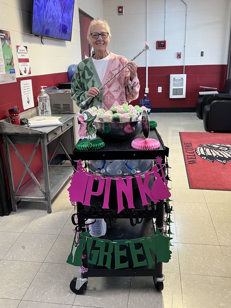 Ms Beth poses with the woot woot cart, all decked out in pink and green