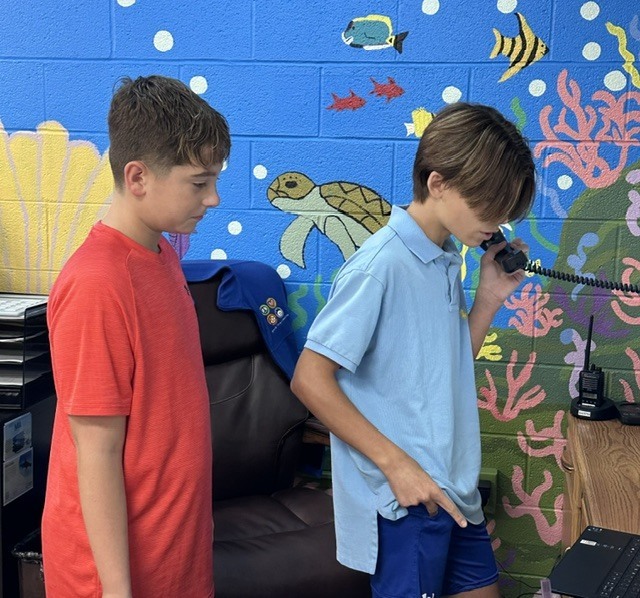 students helping with morning announcements