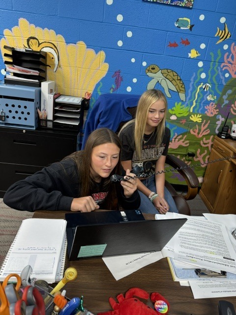 students helping with morning announcements