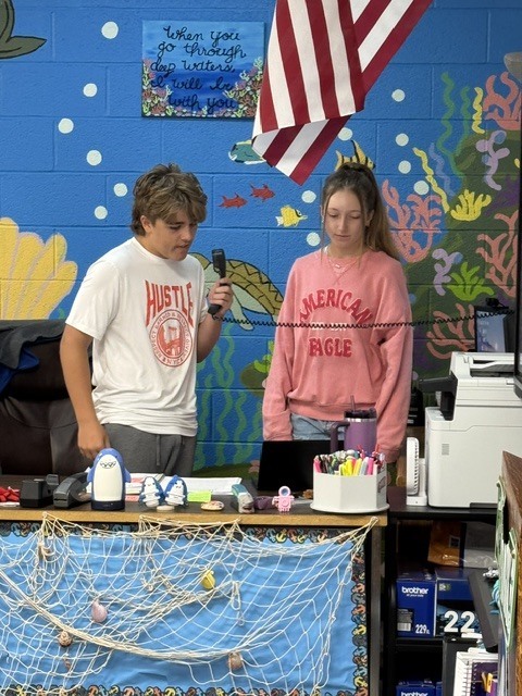 students helping with morning announcements